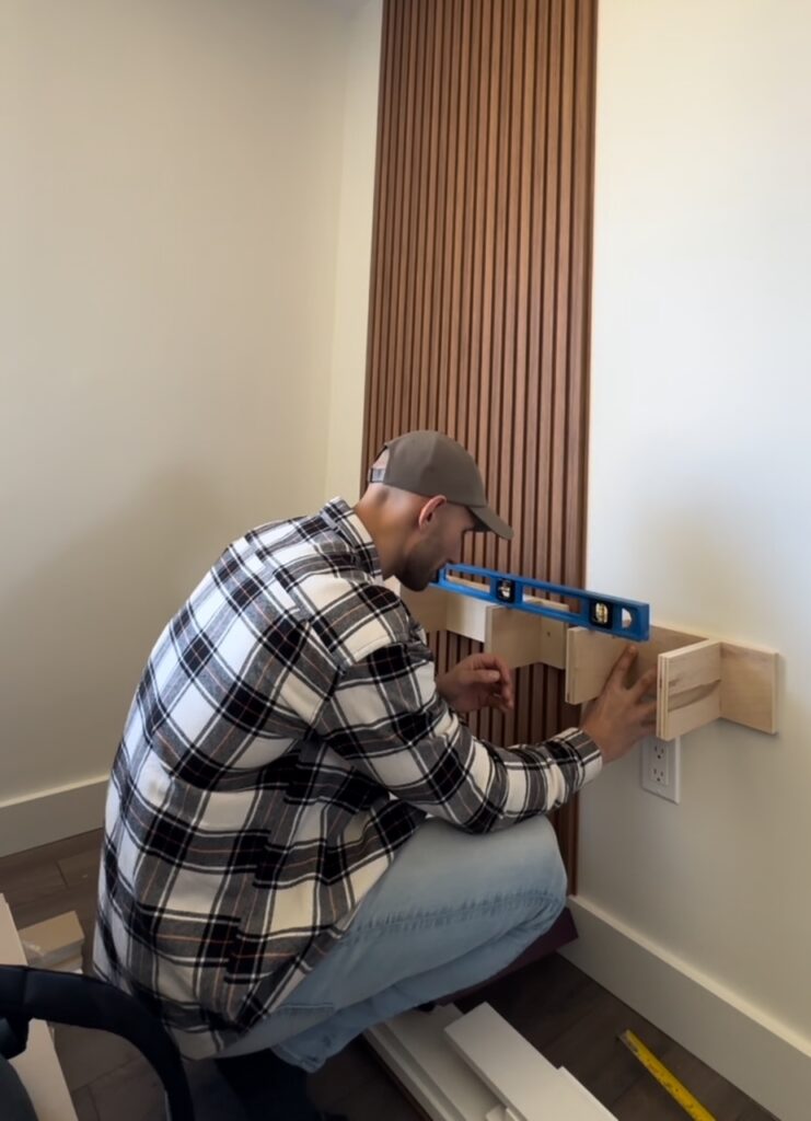 Installing the shelf for DIY wood panel accent wall