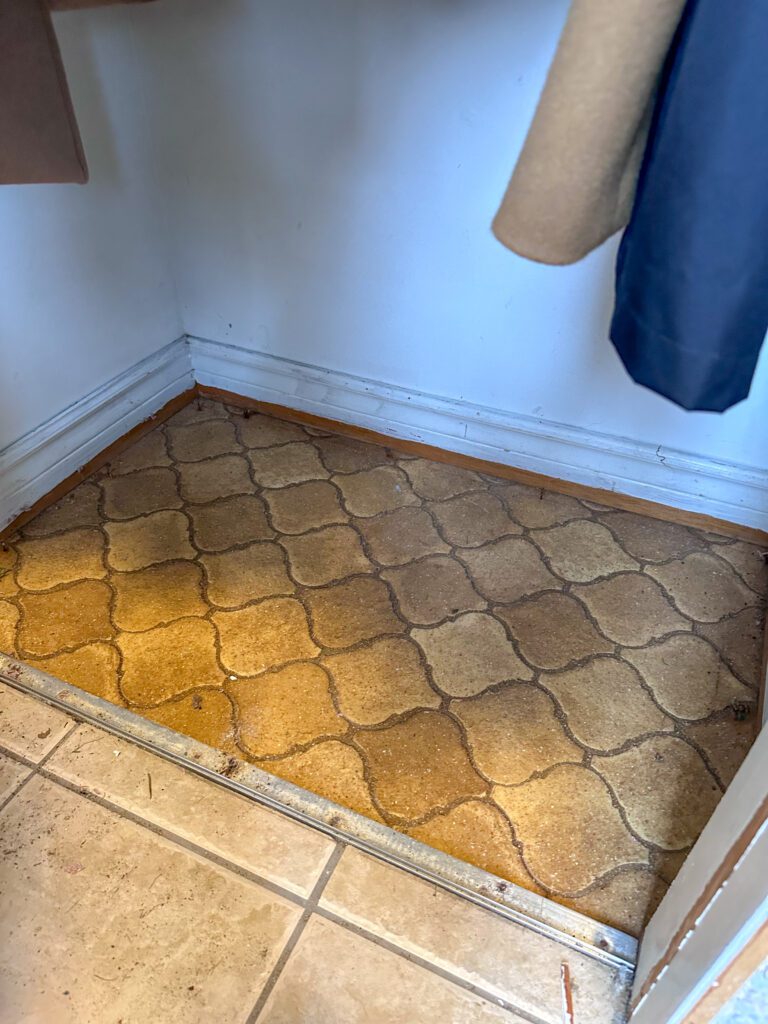 removing old carpet and tile flooring in entryway