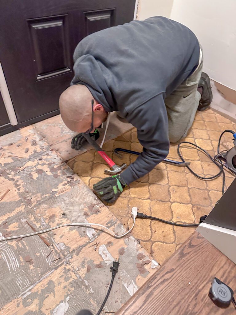 removing tile flooring in the entryway to lay vinyl tile click flooring