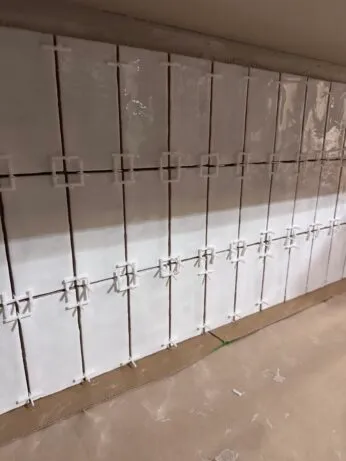 how to apply the adhesive to the tile with the spacers