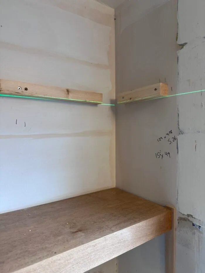 install floating shelves before tiling